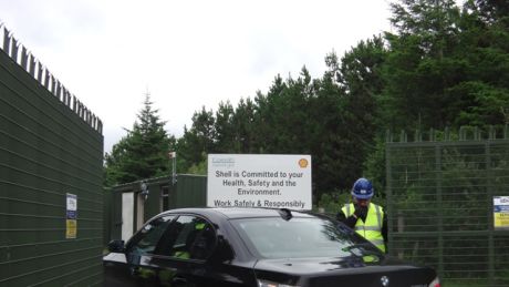 IRMS guard laughing at sign behind him