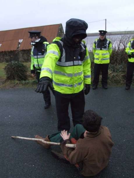 Click on image to see full-sized version Person being pushed out of the road by Gardaí