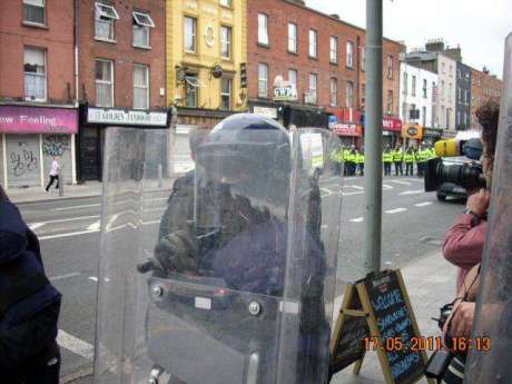 Innocent protesters feel the brunt of the heavily-clad riot squad of the Free State regimes� Gestapo militia, as they rain down baton-blows on the unsuspecting heads of both innocent protesters and bystanders.