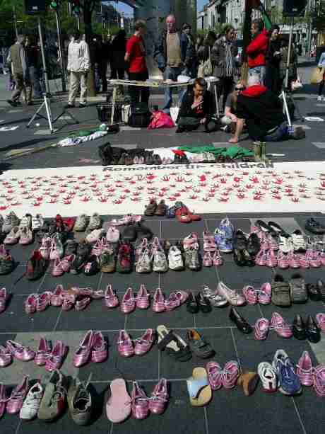Click on image to see full-sized version Children's shoes were placed in front of a memorial banner to remember the children of Palestine
