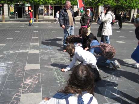 Click on image to see full-sized version Teenagers chalking the names of Palestinian villages on the street